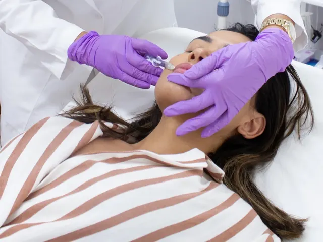 Lip filler being placed with the client lying back on the treatment couch.